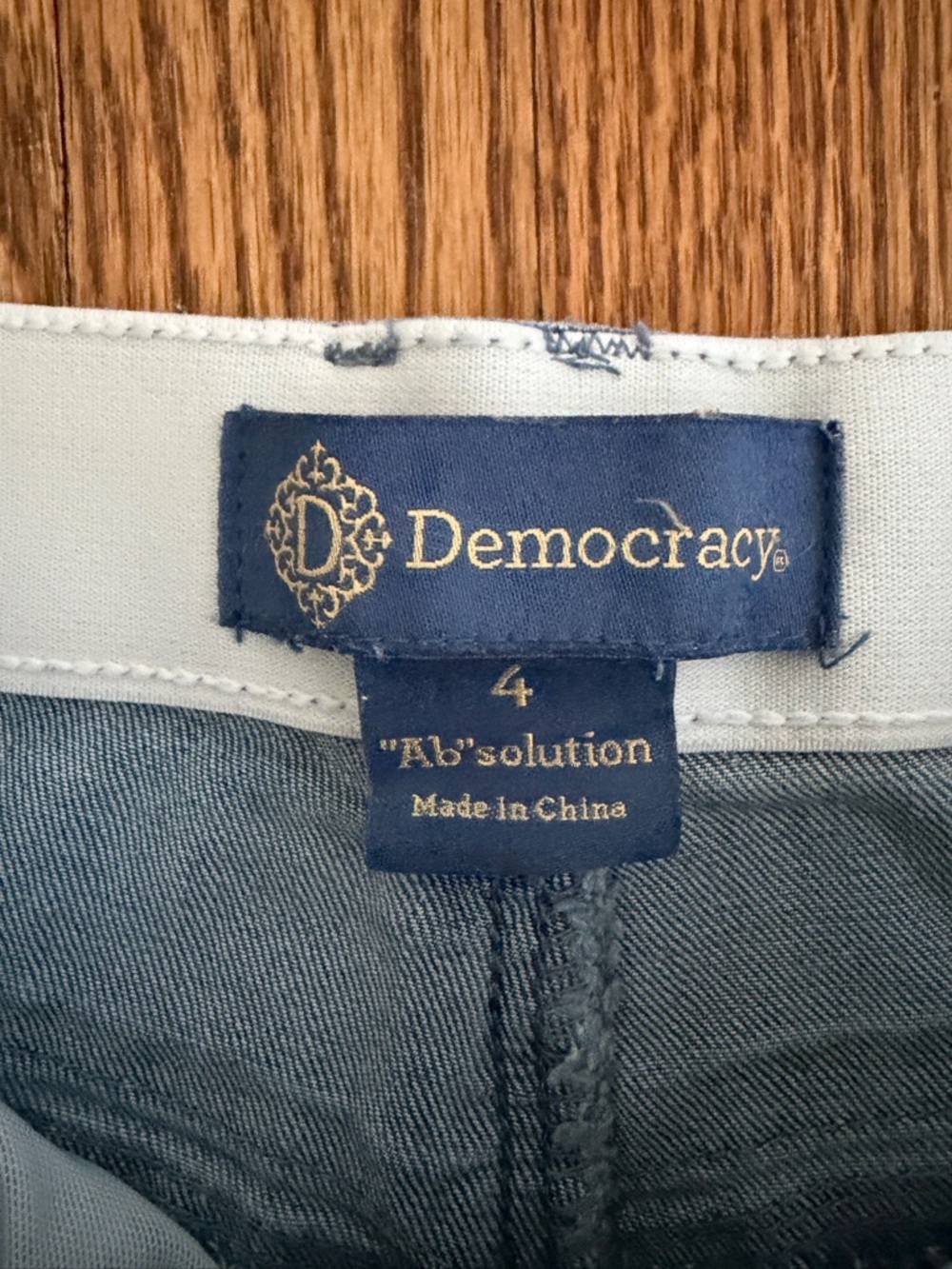 Democracy navy label on light blue denim